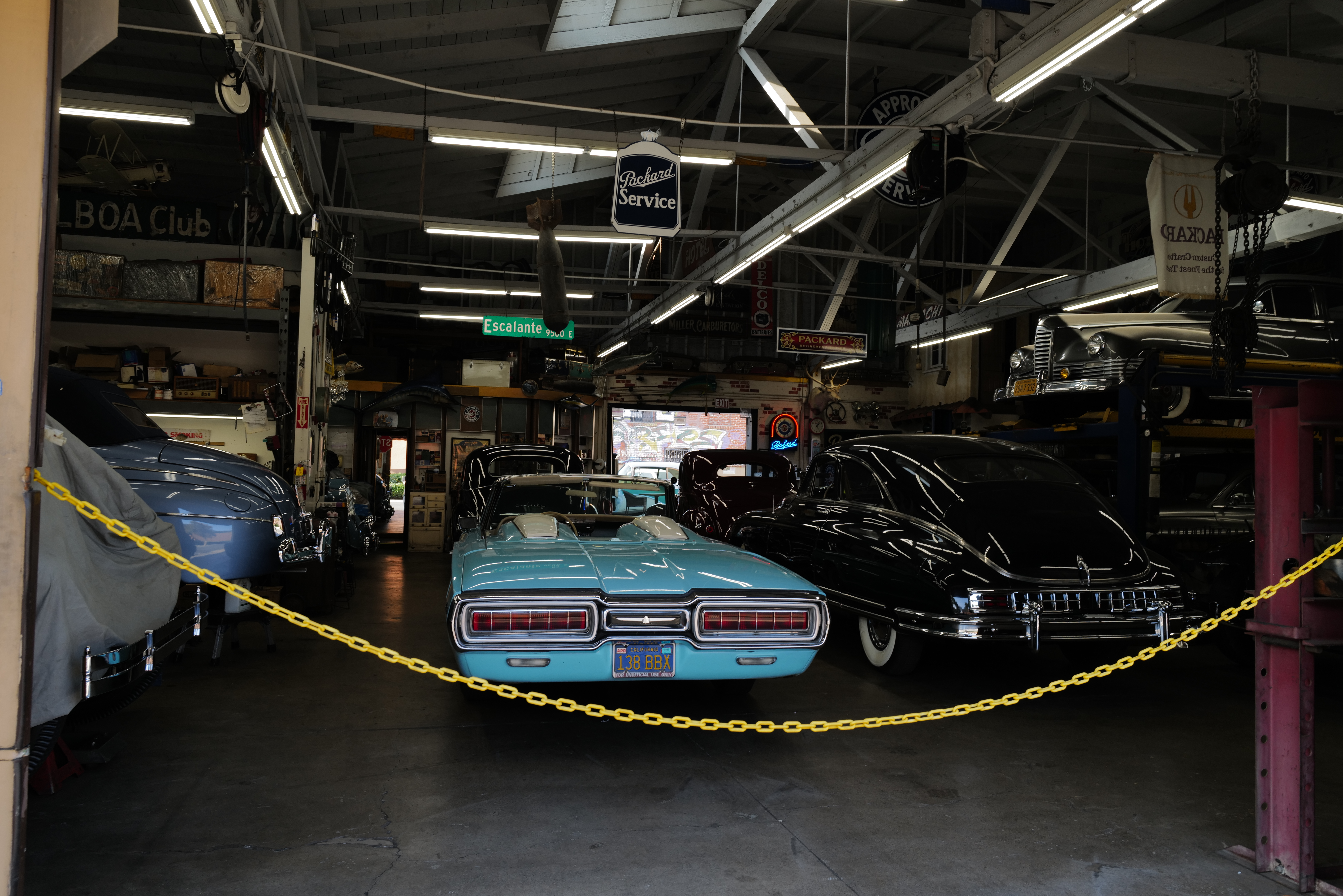 A workshop filled with restored classic American cars.